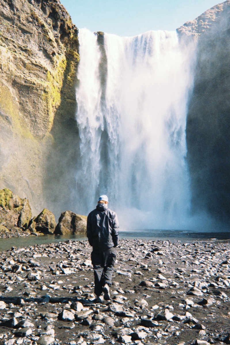 Finn walking toward Skógafoss in Iceland